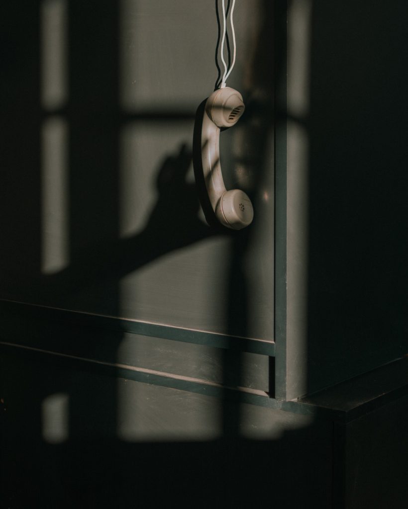 Old Fashioned telephone hanging off the hook